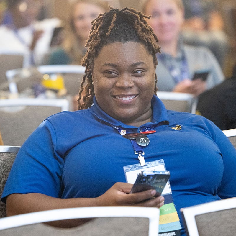2024-Accelerate-Conference-Attendee-sitting-closeup-800x800